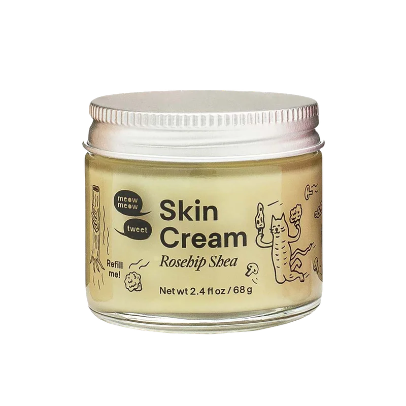 A tan cream in a glass jar with black line illustrations.