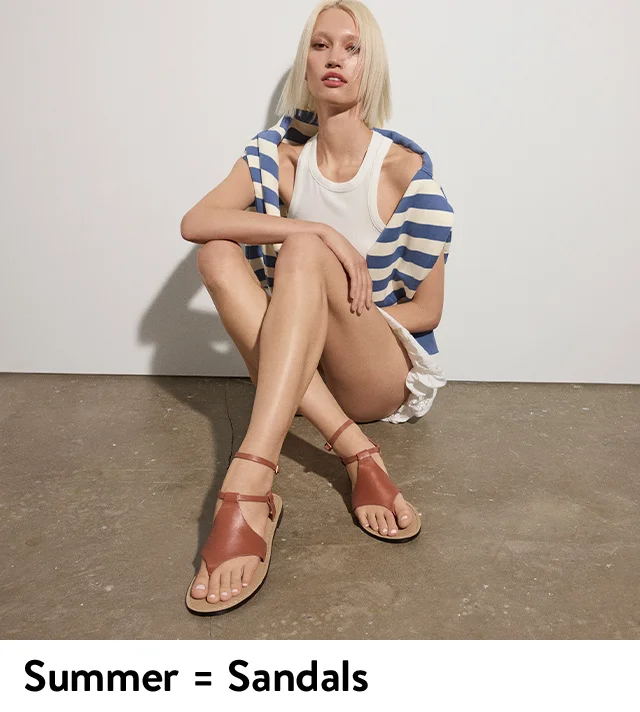 A woman wearing brown sandals.