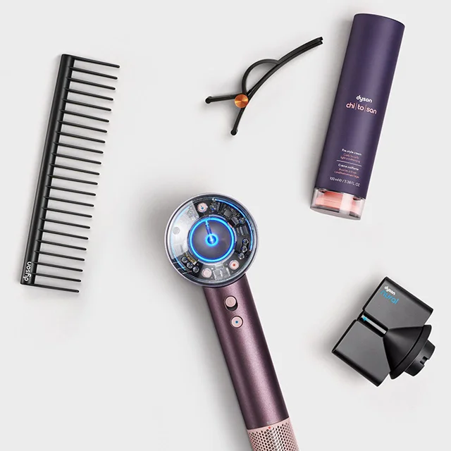 The Dyson Supersonic Nural hair dryer surrounded by attachments and accessories