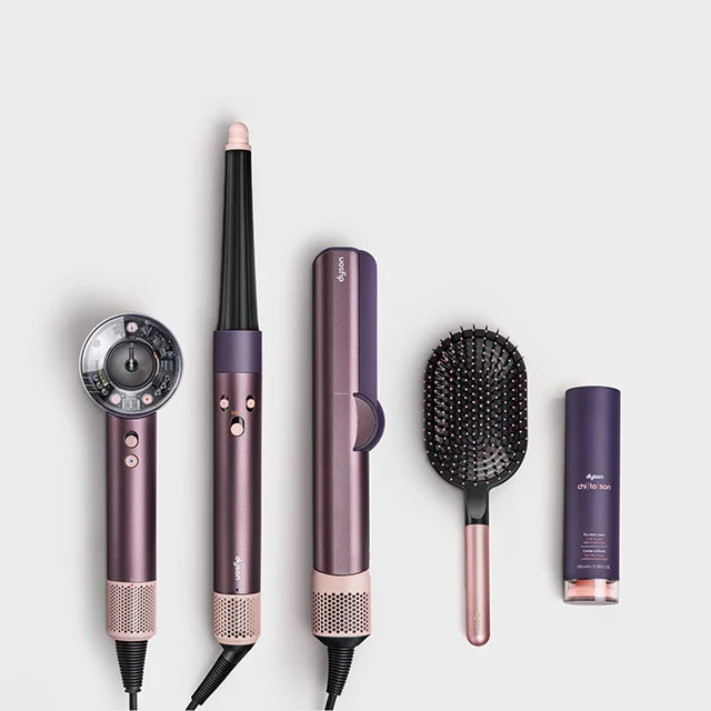 Dyson hair care range in Jasper plum colorway, the Paddle brush, and Chitosan styling product