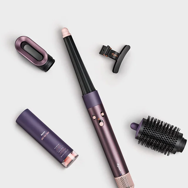 The Dyson Airwrap i.d. multi-styler and dryer surrounded by attachments and accessories
