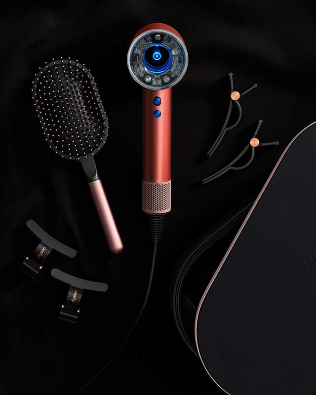 The Dyson Airwrap i.d. multi-styler and dryer in Strawberry bronze. With Dyson-designed Detangling comb, Hair clips and Heat-proof mat.