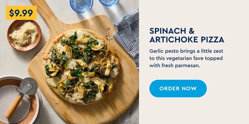 Spinach & Artichoke Pizza - Garlic pesto brings a little zest to this vegetarian fave topped with fresh parmesan.
