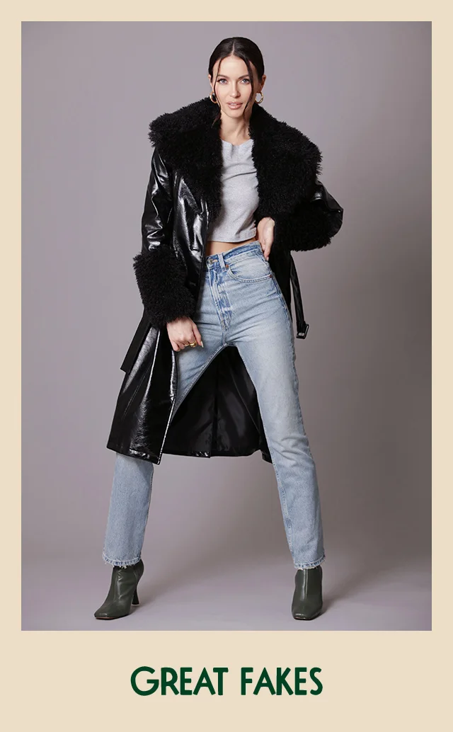A woman wearing a black faux-leather coat with faux-leather trim.