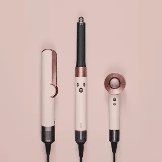 The Dyson hair care range in Ceramic pink and rose gold being revealed by silk