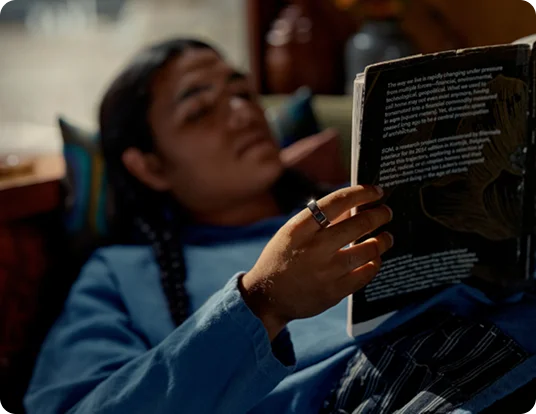 Person reading wearing Oura Ring