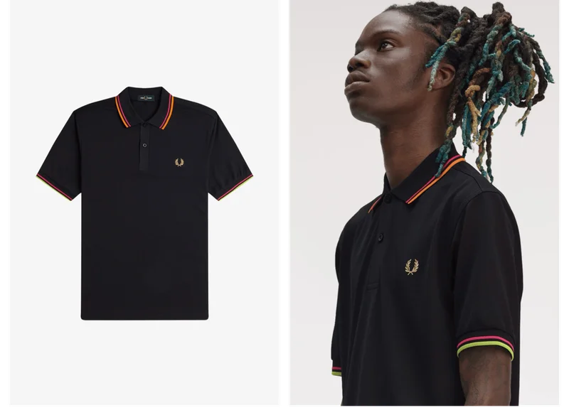Black male model wears a Twin Tipped Fred Perry Tennis Shirt in Black / Bright Pink / Bright Orange