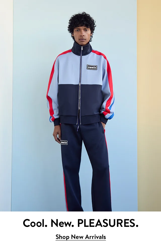 A man wearing a track jacket and track pants from PLEASURES.