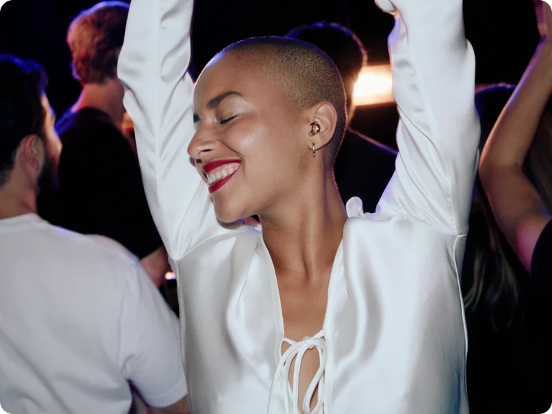 A woman dancing with Loop Switch in her ears.