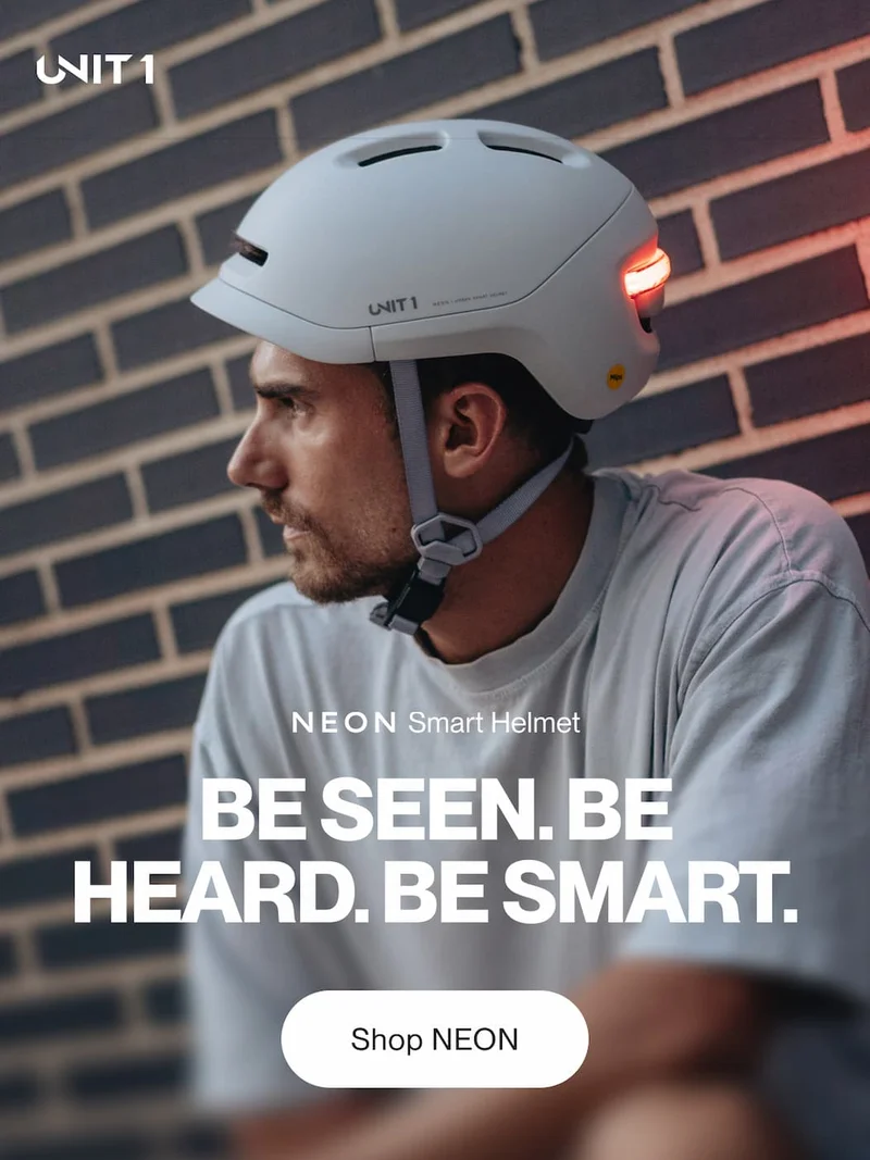 Rider wearing the UNIT 1 NEON Smart Helmet — Be seen. Be heard. Be smart.