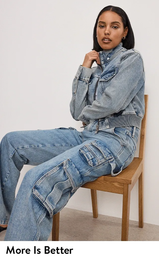 A woman wearing a denim jacket and jeans.