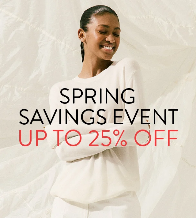 Spring Savings Event up to 25% off; woman wearing a white sweater and pants.