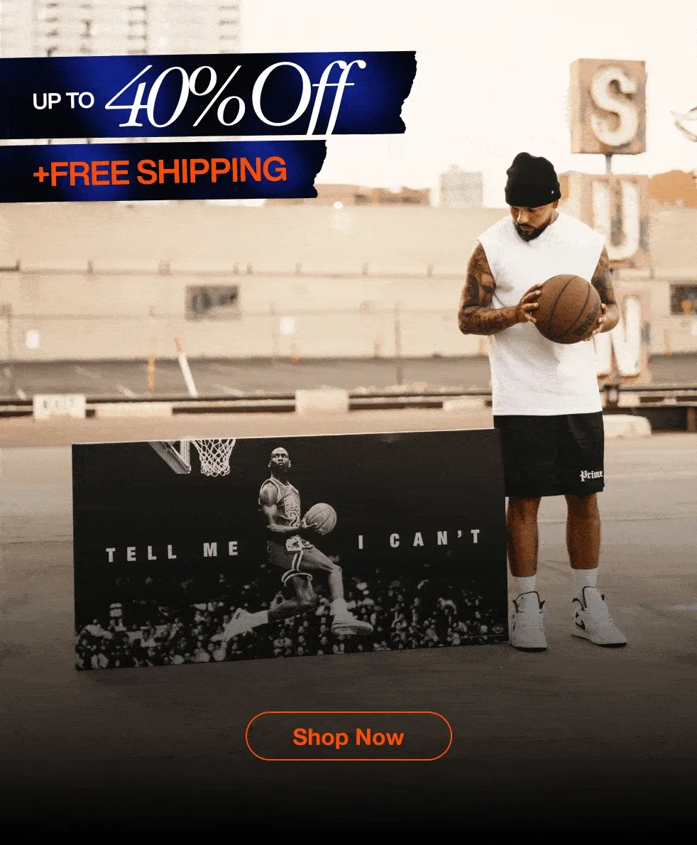 A rotating series of interior lifestyle images showcasing different IKONICK canvas art pieces on sale. Each frame shows a unique canvas displayed in a stylish room setting—ranging from modern living rooms and home offices to gym-inspired spaces—with bold sale pricing overlaid at the top in blue-orange graphics and a “Save Now” button at the bottom. Featured canvases include: the navy “TRAVEL – Money Returns, Time Does Not” design, the “Man in the Arena” Colosseum piece, a Michael Jordan underwater-style artwork, the Monopoly-inspired “Rent Due” piece, a Tiger Woods “Mindset Is Everything” canvas, and a Snoopy motivational artwork. The environments are warm, cinematic, and upscale, highlighting each canvas as a premium décor item.