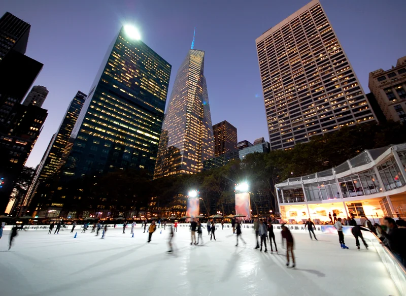 Ice skaters in Bryant Park at night