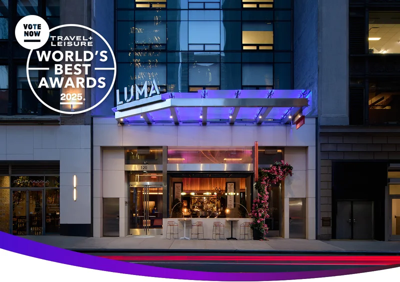 Exterior of LUMA Hotel Times Square at night with World's Best Award logo