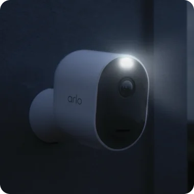 Front door of home with various Arlo home security products mounted on the exterior.