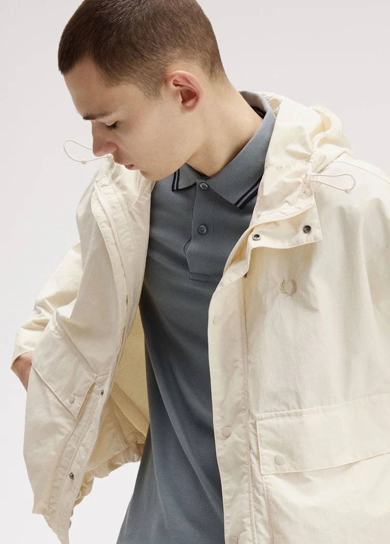 Male model wearing a Fred Perry Cropped Ripstop Parka in Ecru