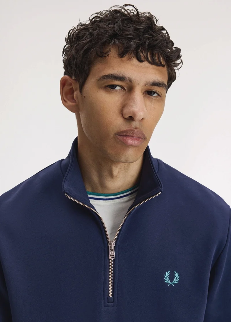 Male model wearing a Fred Perry Half-Zip Sweatshirt in Blue