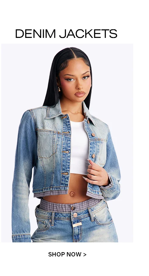 Woman wearing a two-tone light blue cropped denim jacket, white crop top, and distressed jeans. Shop the latest denim jacket styles.