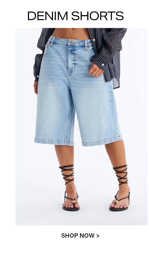 Model wearing light wash denim shorts, a striped shirt, and black lace-up sandals, cropped from waist down. Shop our new denim shorts collection.