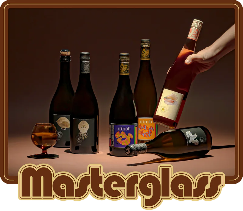 Lineup of Pat Sullivan wines on an orange bench with shadows from the lighting.