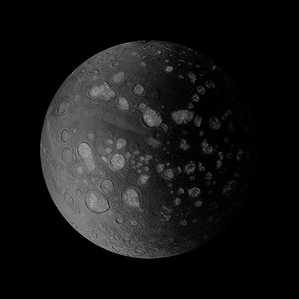 A black and white photo of a pancake that looks like a moon