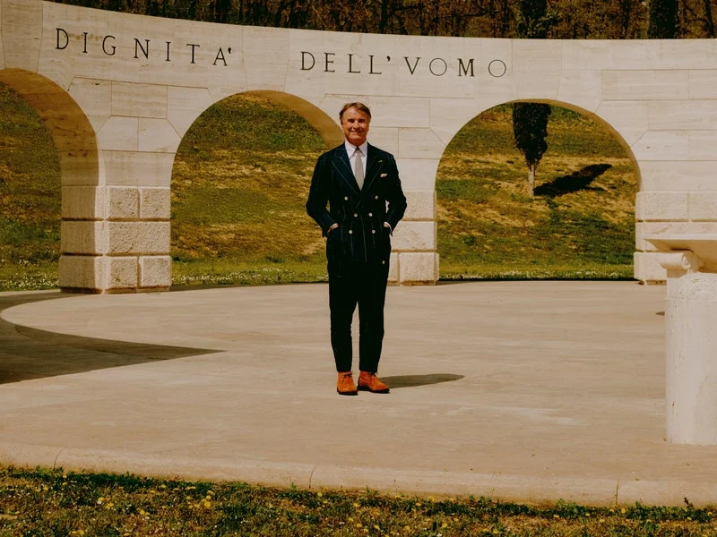 Image may contain: Jonathan Aitken, Clothing, Formal Wear, Suit, Coat, Grass, Plant, Adult, Person, Nature, and Outdoors