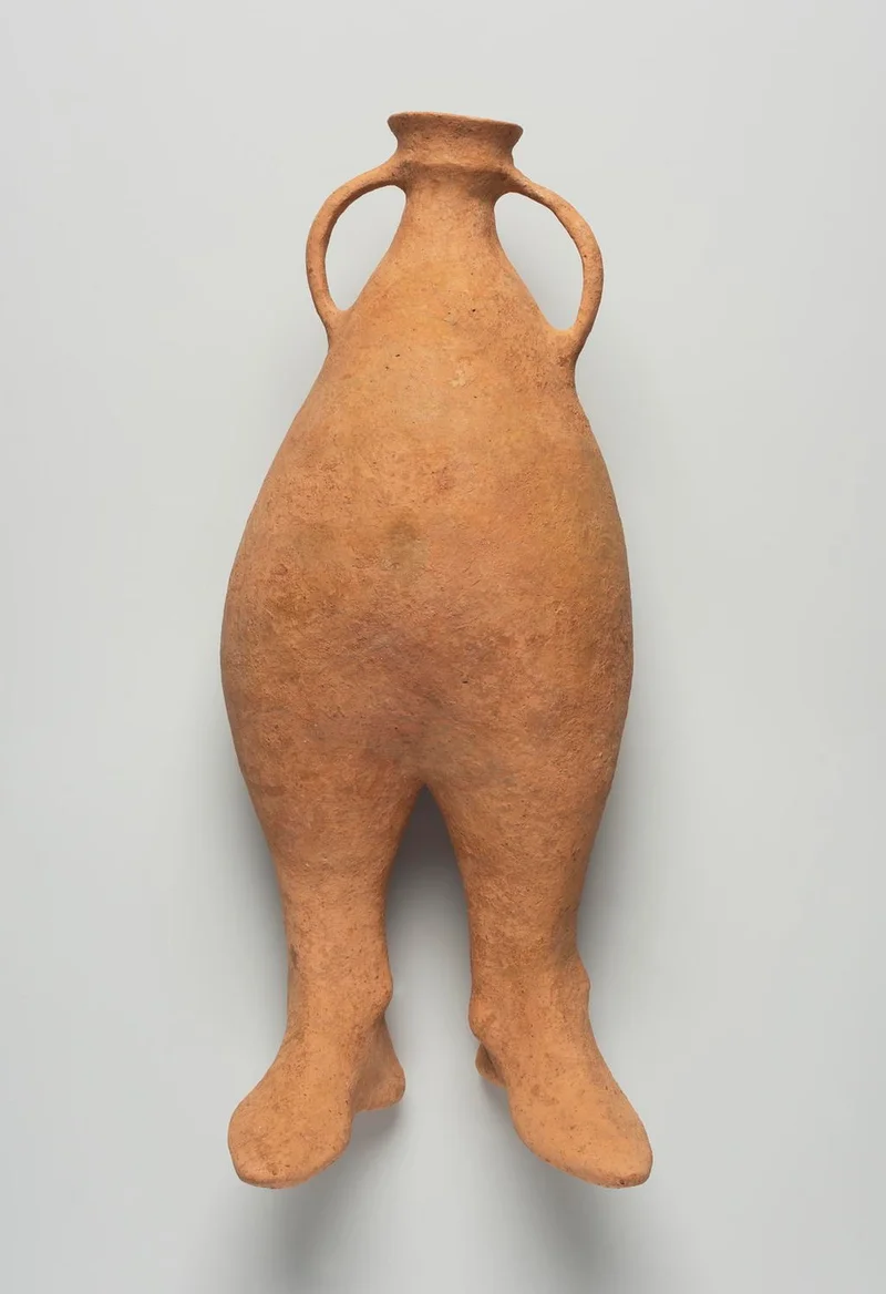 Earthenware vessel with two feet at the bottom and round handles at the top
