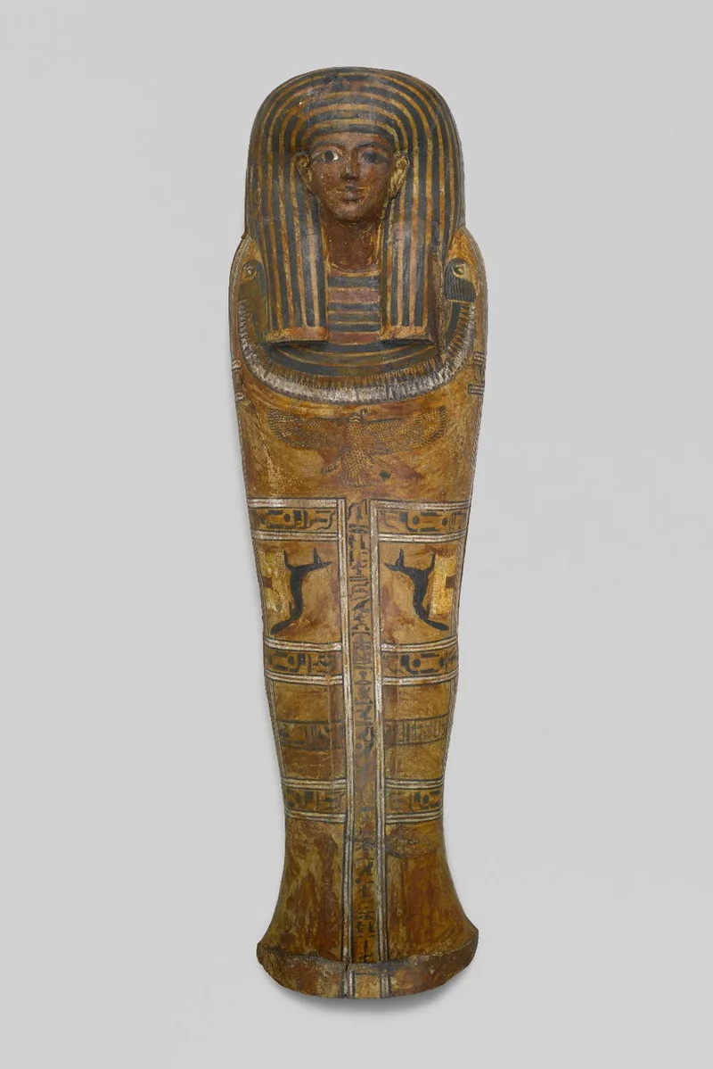 Black and yellow coffin with animal figures illustrated on the sides