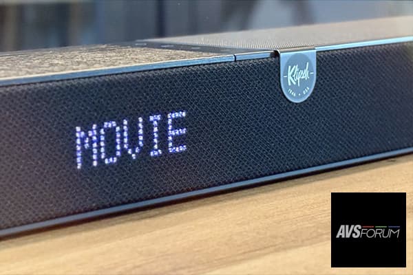 Close-up on a Klipsch Flexus soundbar, with thee word “Movie” light on it.