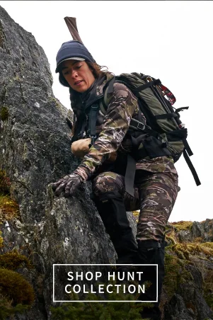 Gerber female ambassador climbing down rocks in hunting camos Gerber female ambassador climbing down rocks in hunting camos