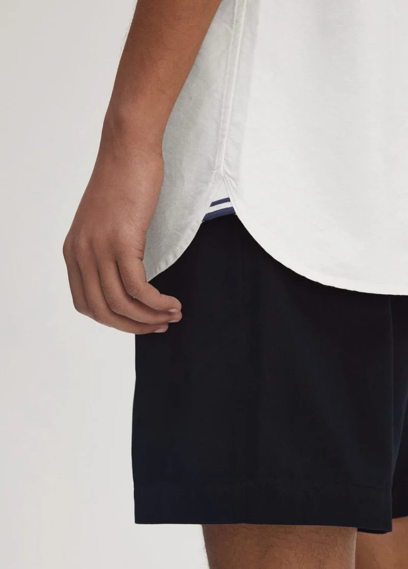 Detail of white scallop-edged shirt