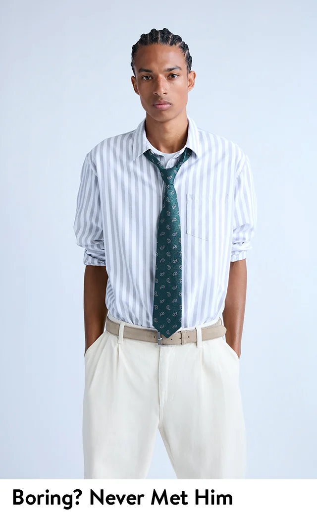 A man wearing a striped shirt and patterned tie.