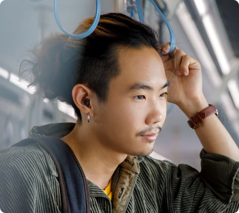 Man in the subway wearing Loop Quiet in Black