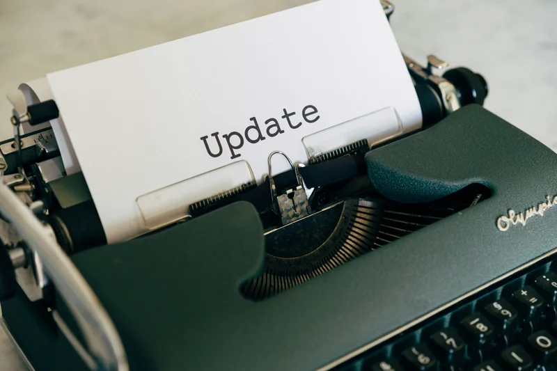 Image of a typewriter with the word Update typed on a piece of paper.
