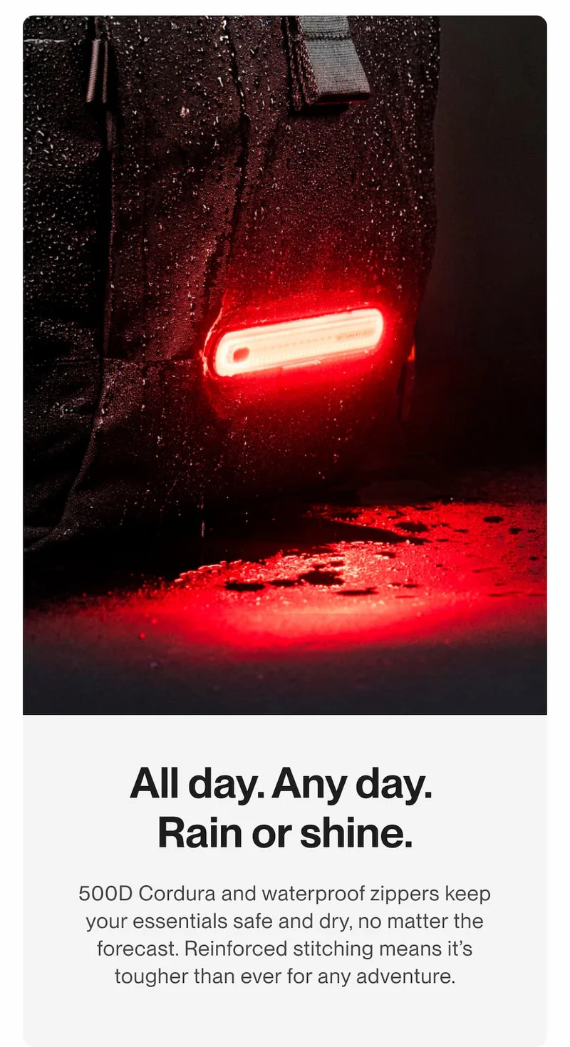 Close-up of the TORCH backpack with water droplets and the Smart Light shining red in wet conditions.