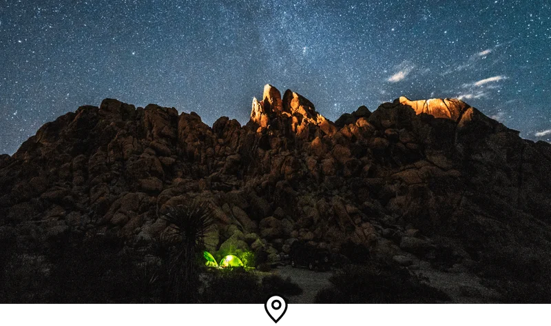 Image Description: A rock formation under a starry night sky in Joshua Tree National Park, California