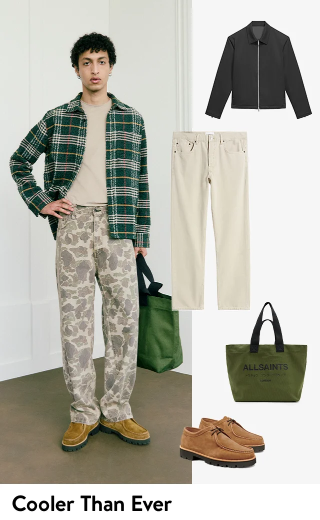 A man wearing a plaid jacket with a plain T-shirt and floral pants. Black zip jacket, off-white pants, green tote, suede shoes.