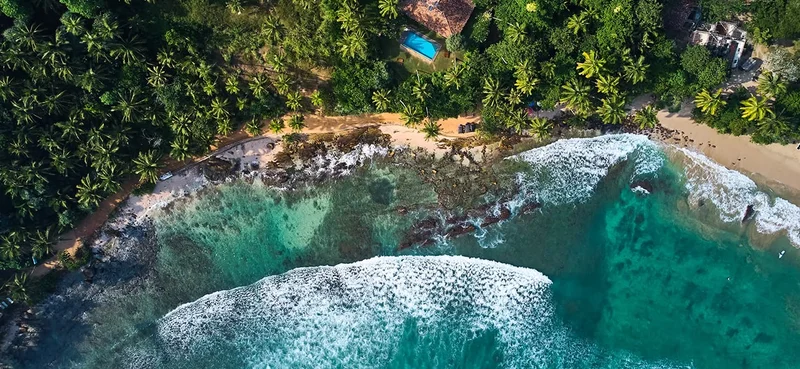 Aerial view of Hiriketiya Beach in Dikwella. Blue beach in Sri Lanka.