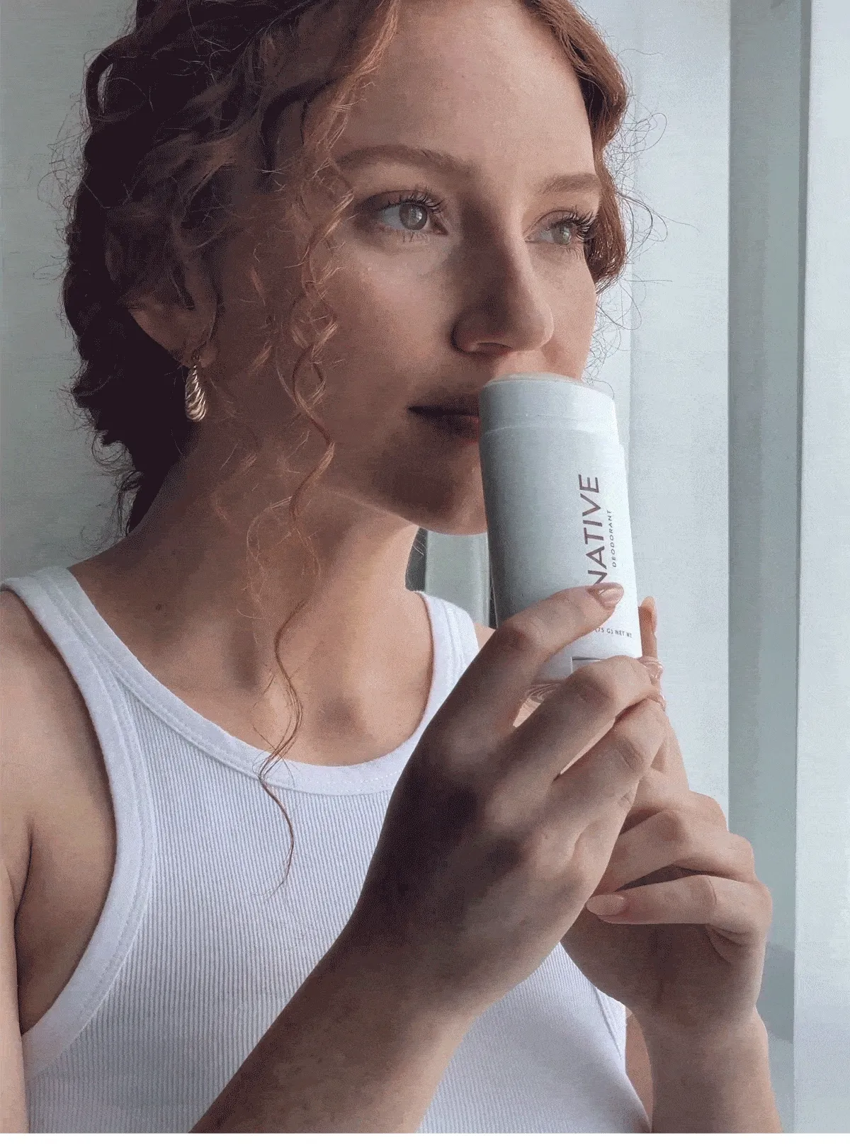 Girl smelling Native Deodorant