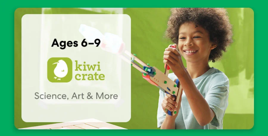 Young child smiling while working on a science experiment from KiwiCo Labs. Hands-on STEM learning for ages 6–9
