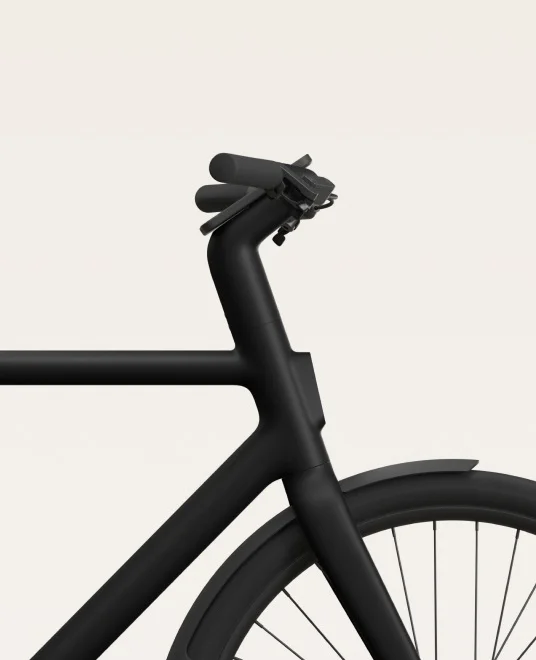 A render. Smartphone mounted on Cowboy e-bike handlebars displaying navigation and speed.