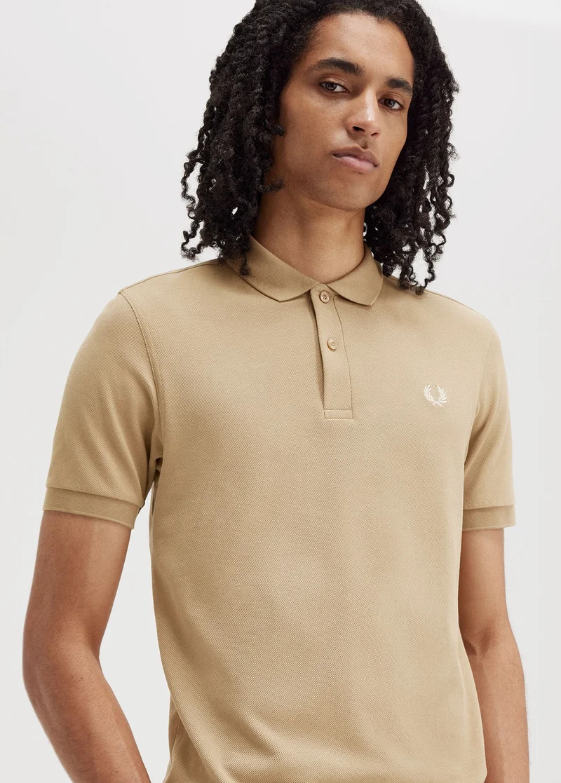 Male model wearing beige Fred Perry Shirt