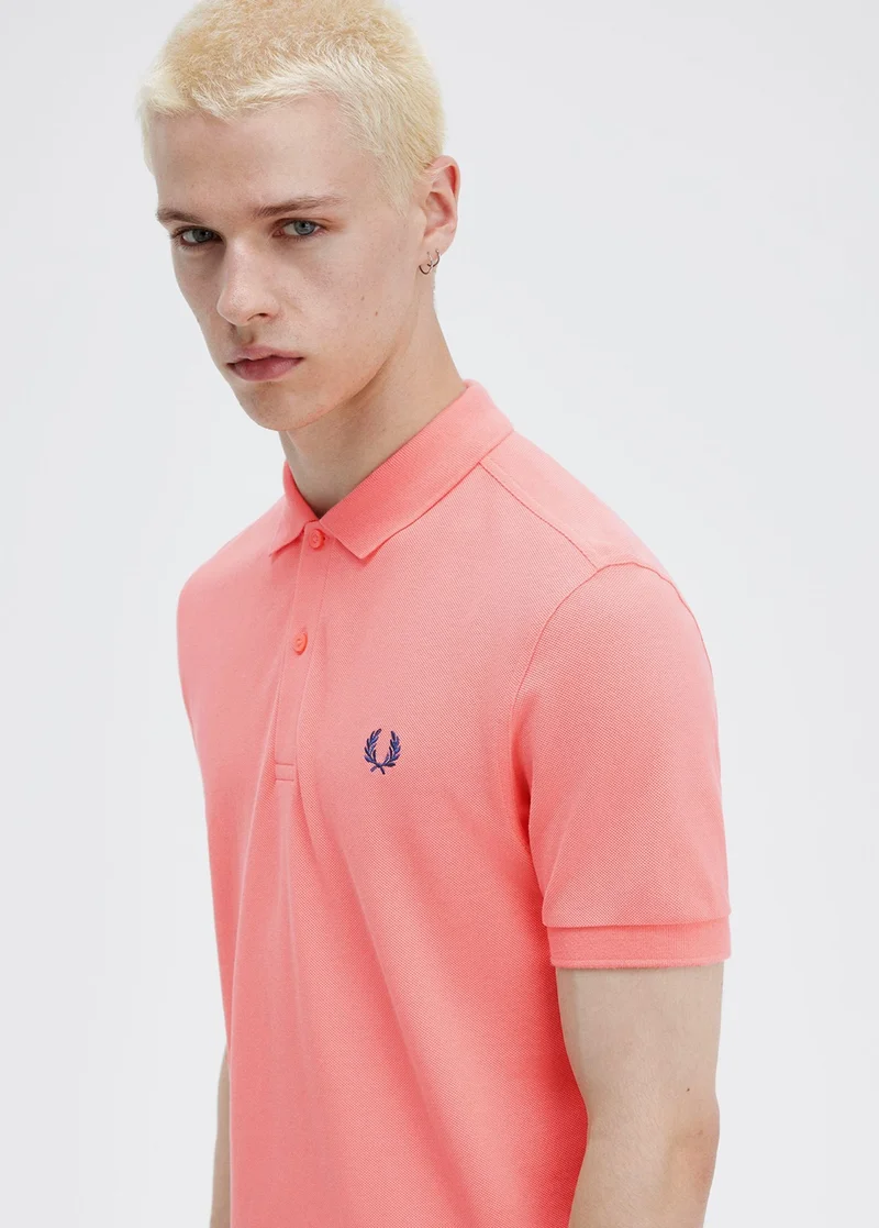 Male model wearing pink Fred Perry Shirt