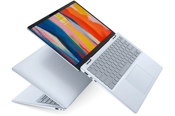 Two Dell 14 Plus laptop computers floating in midair.