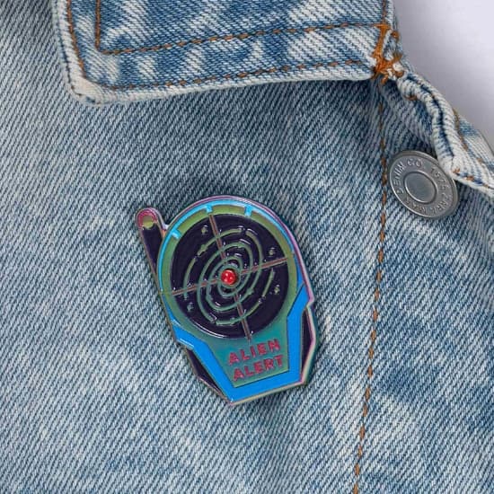 Close up of Alien Alert Pin pinned to jacket