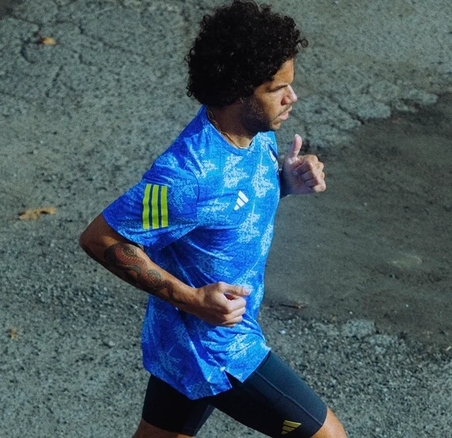 Man running in blue Boston Marathon apparel