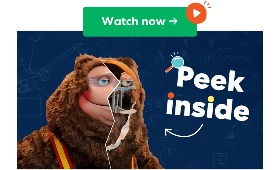 Large animatronic orangutan holding up blueprints. Text overlay: Peek inside