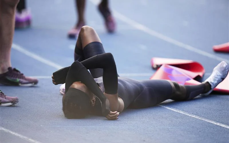 Faith Kipyegon, from Kenya, lies on the track after crossing the finish line in her attempt to become the first woman to run a mile in under four minutes, at Stade Charlety in Paris, Thursday, June 26, 2025.