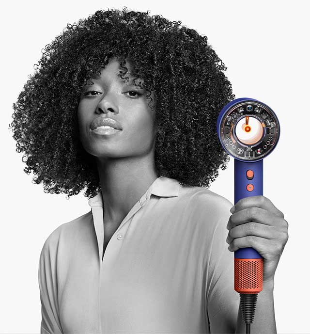 A model using the Dyson Supersonic Nural hair dryer